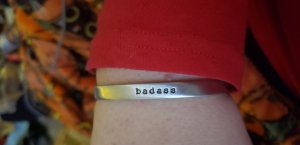 Amazing bracelet I bought from CynicalRedhead on Etsy that says badass. 